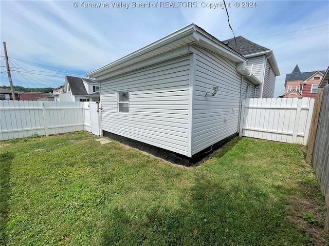 view of side of home featuring a lawn