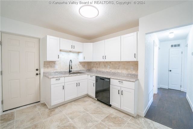 kitchen with backsplash, sink, black dishwasher, and white cabinets