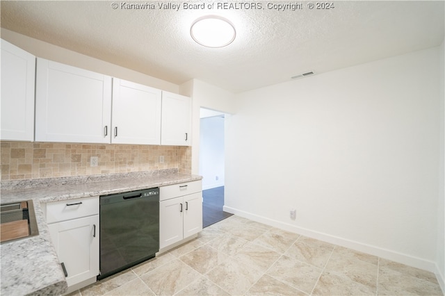 kitchen featuring light stone counters, black dishwasher, a textured ceiling, tasteful backsplash, and white cabinetry