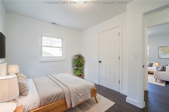 bedroom featuring dark wood-type flooring