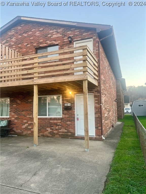 exterior space with a patio, a deck, and a balcony