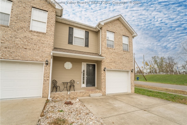 townhome / multi-family property featuring a garage