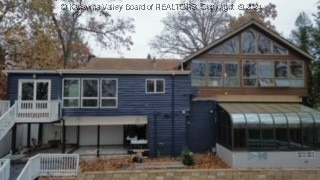 back of house with a sunroom