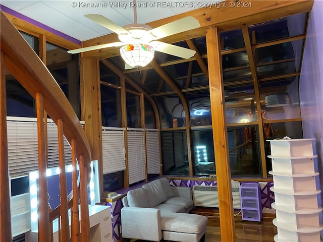 unfurnished living room featuring ceiling fan and dark hardwood / wood-style flooring