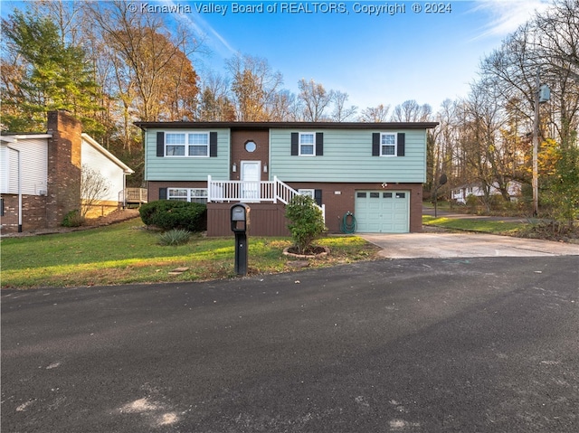 bi-level home with a garage and a front yard