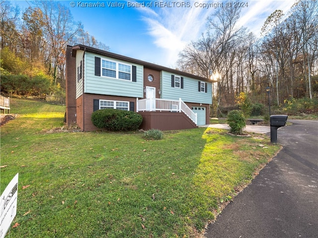 raised ranch with a front yard and a garage