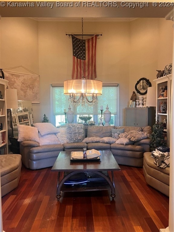 living room featuring a chandelier and dark hardwood / wood-style floors