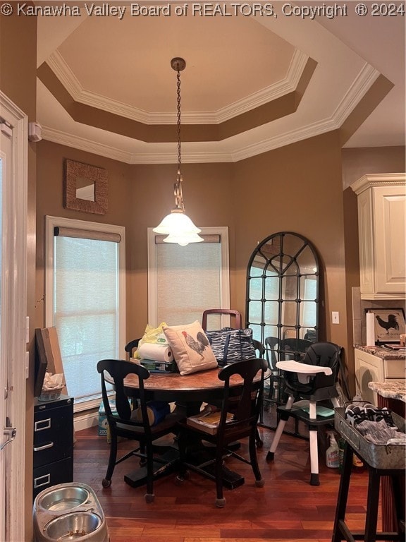 dining area featuring dark hardwood / wood-style floors, crown molding, and a tray ceiling