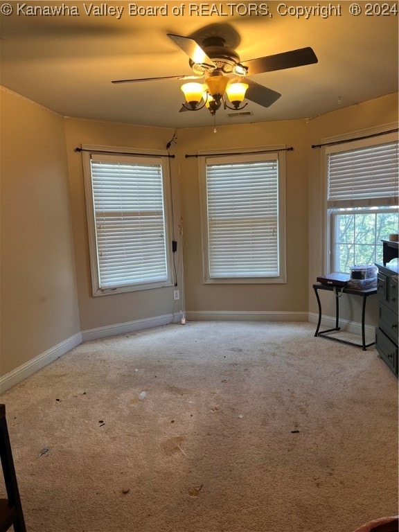 unfurnished room with light carpet and ceiling fan