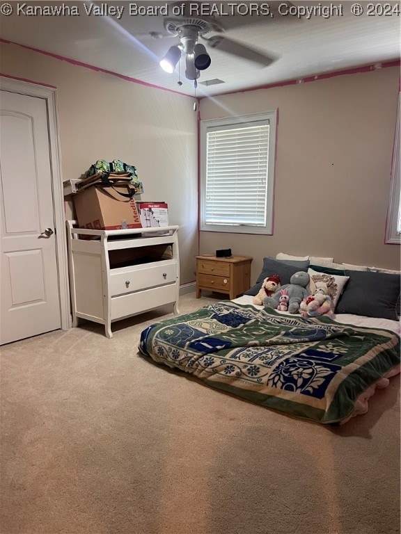 carpeted bedroom with ceiling fan