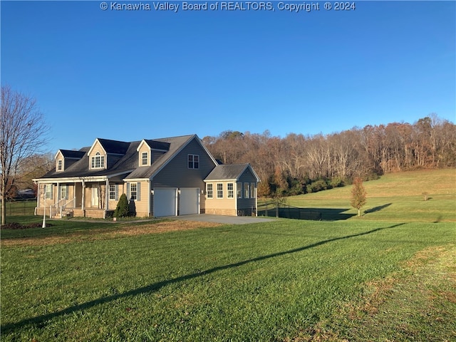 view of side of property with a porch, a garage, and a yard