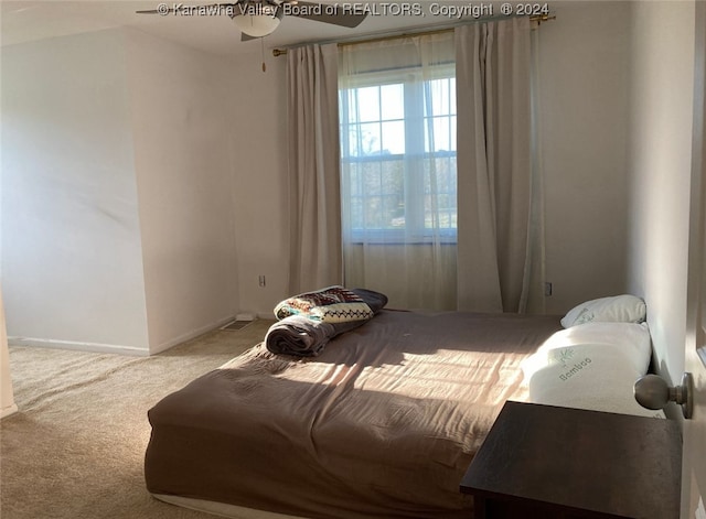 carpeted bedroom with ceiling fan