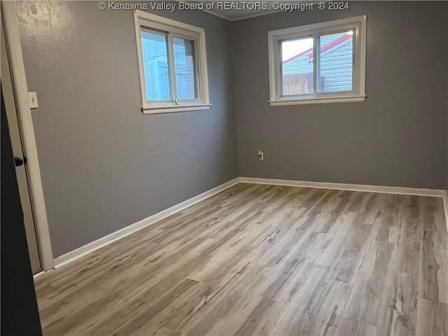 spare room with light hardwood / wood-style flooring