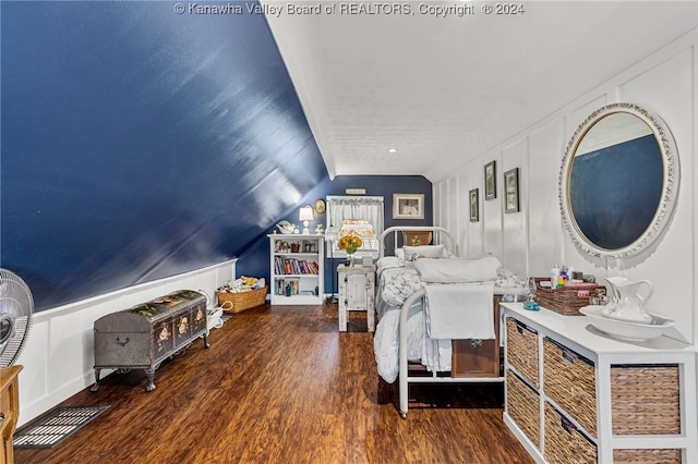 bedroom with dark wood-type flooring and vaulted ceiling