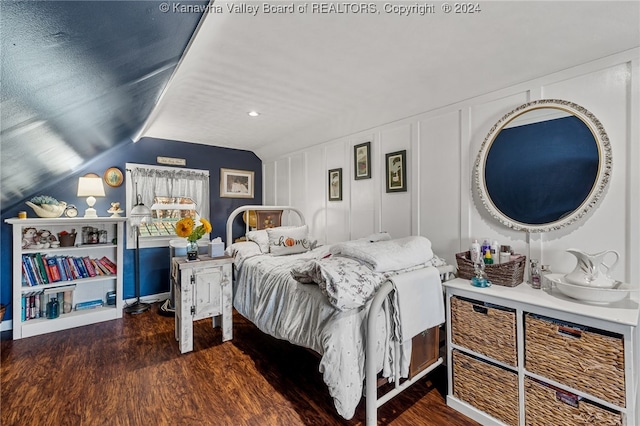 bedroom with dark hardwood / wood-style floors and lofted ceiling