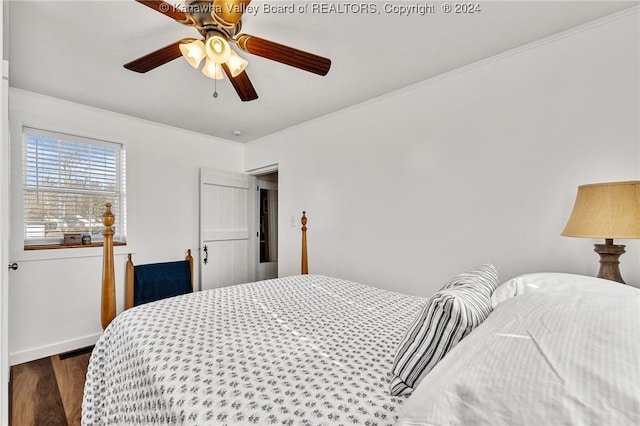 bedroom with ceiling fan, dark hardwood / wood-style floors, and crown molding