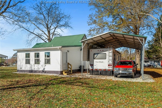 exterior space featuring a carport and a lawn