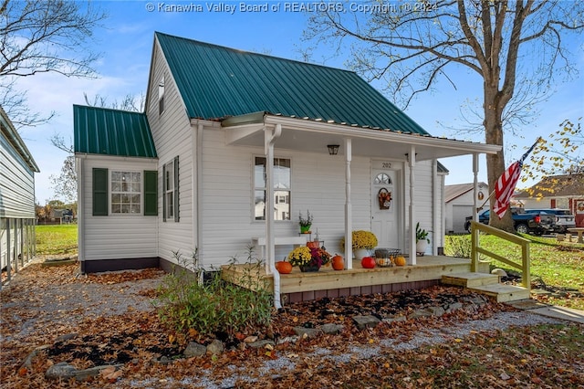 rear view of house featuring covered porch