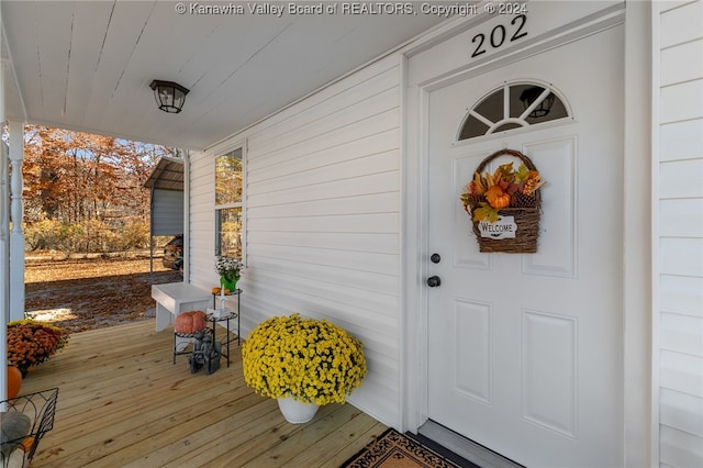 view of exterior entry with a porch