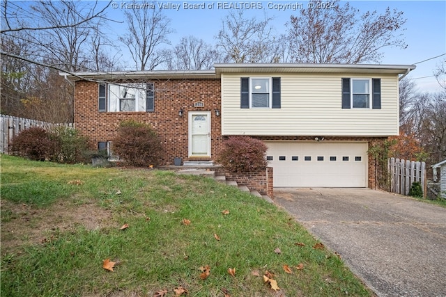 bi-level home featuring a garage and a front yard