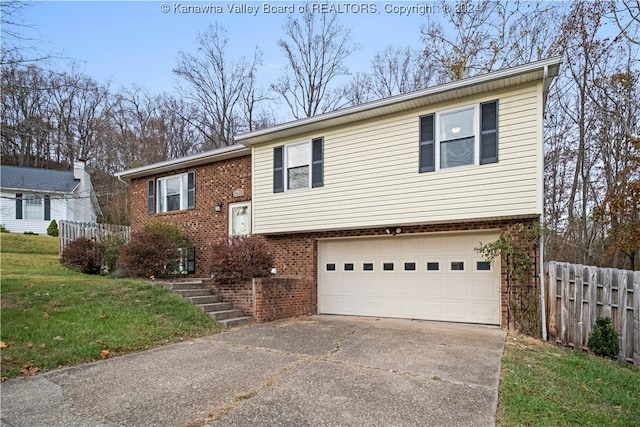 bi-level home with a front yard and a garage