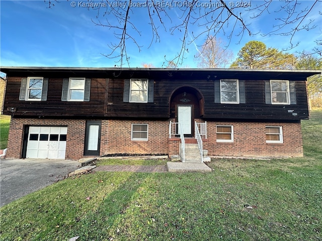 bi-level home with a front lawn and a garage