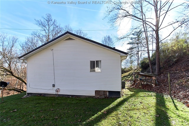 view of property exterior with central air condition unit and a lawn