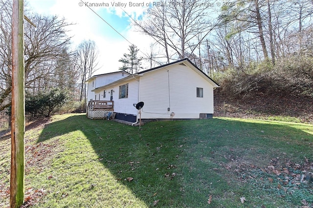 view of side of home featuring a deck and a yard