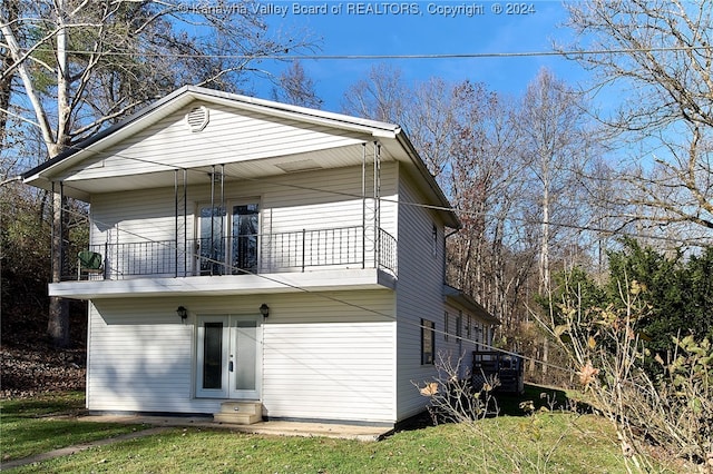 back of house with a balcony