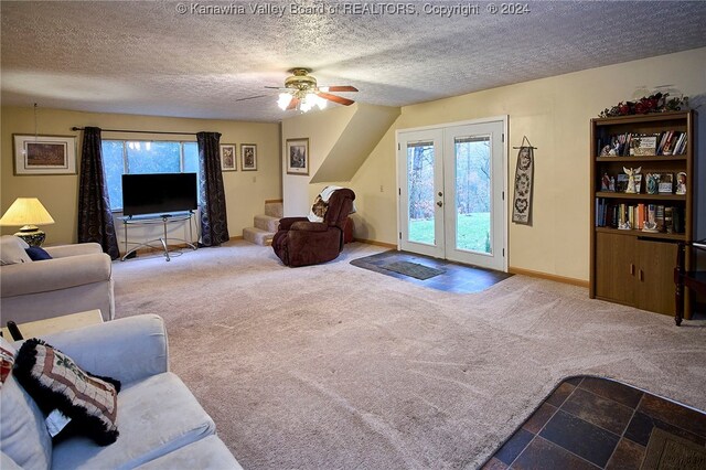 living room featuring carpet, a textured ceiling, and a wealth of natural light