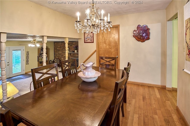 dining area featuring light hardwood / wood-style floors and ceiling fan with notable chandelier