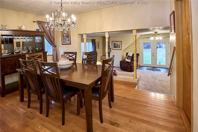 dining space featuring ceiling fan with notable chandelier, decorative columns, french doors, and light hardwood / wood-style flooring