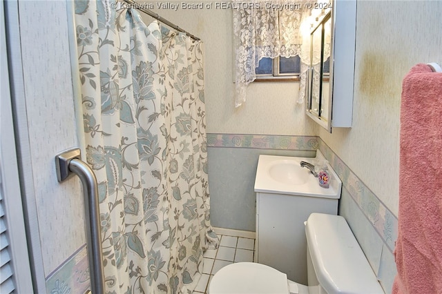 bathroom with tile patterned floors, vanity, toilet, and a shower with curtain