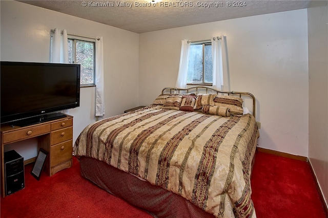 carpeted bedroom featuring a textured ceiling