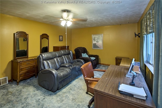 office space with a textured ceiling, carpet floors, and ceiling fan