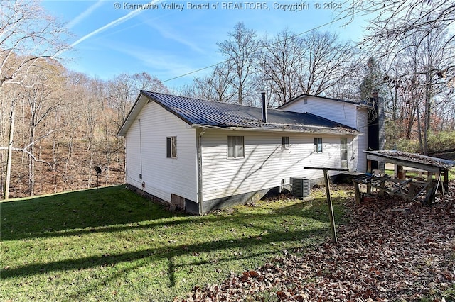 view of home's exterior with a yard and central AC unit