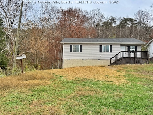 view of front of home featuring a front lawn and a deck