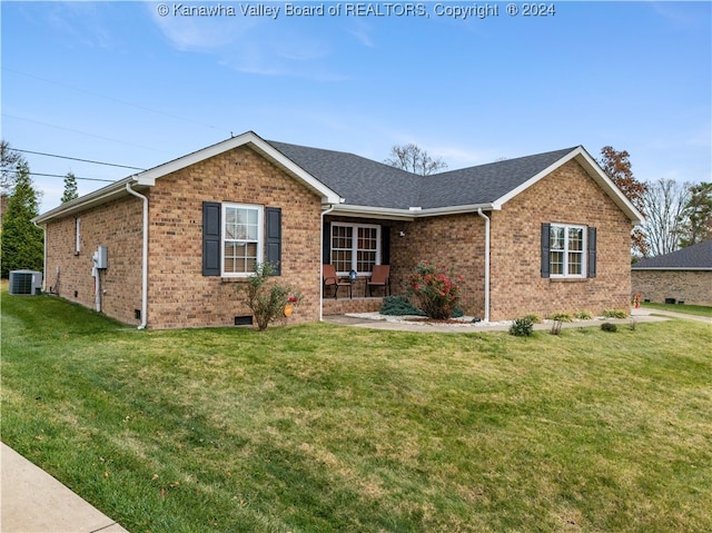 ranch-style house featuring a front yard and cooling unit