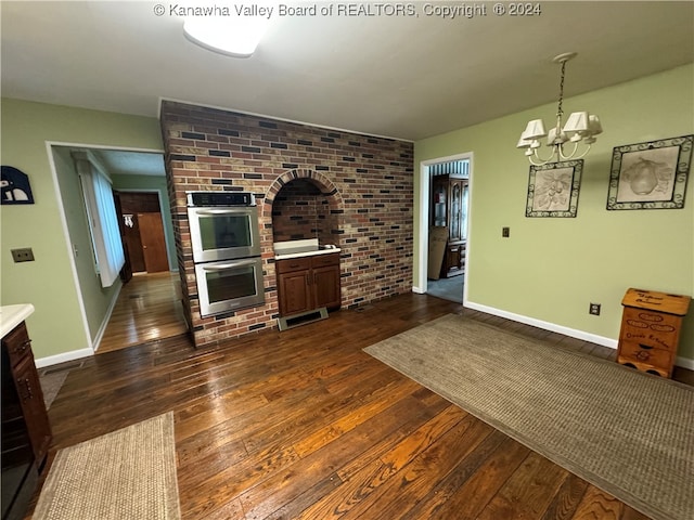 living room with a chandelier and dark hardwood / wood-style flooring