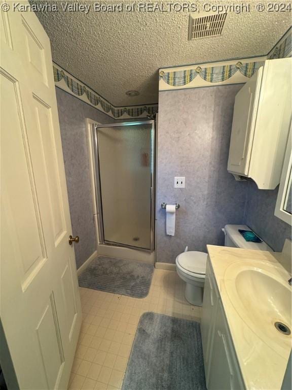 103 Central Ave, Logan, WV 25601 - bathroom featuring vanity, a shower stall, and a textured ceiling