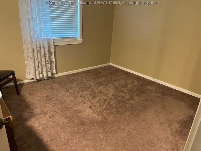 empty room featuring dark carpet