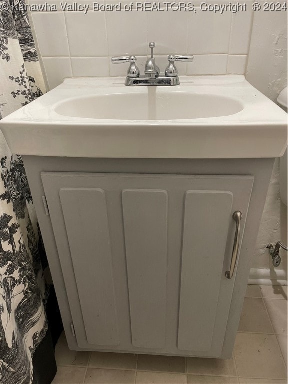 bathroom with tile patterned flooring and vanity