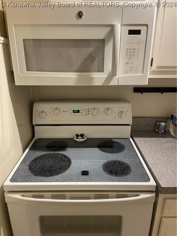 room details with white cabinets and white appliances