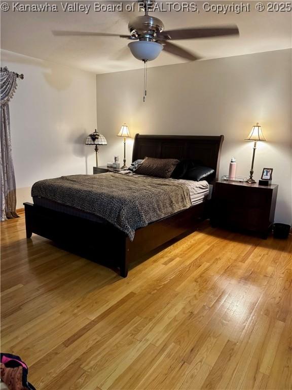 bedroom with ceiling fan and light wood-type flooring