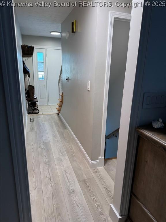 hallway with light wood-type flooring