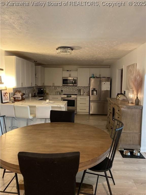 dining area featuring light wood-type flooring