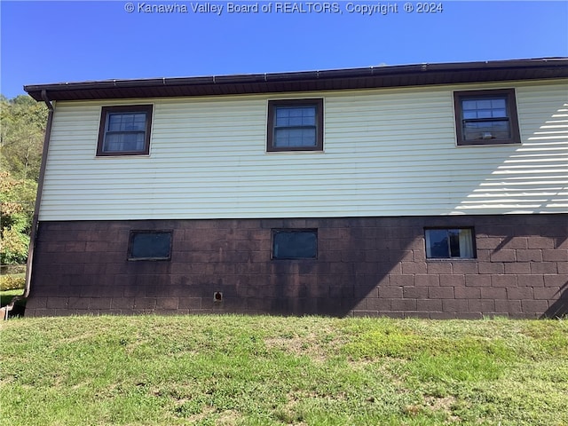 view of side of home with a lawn