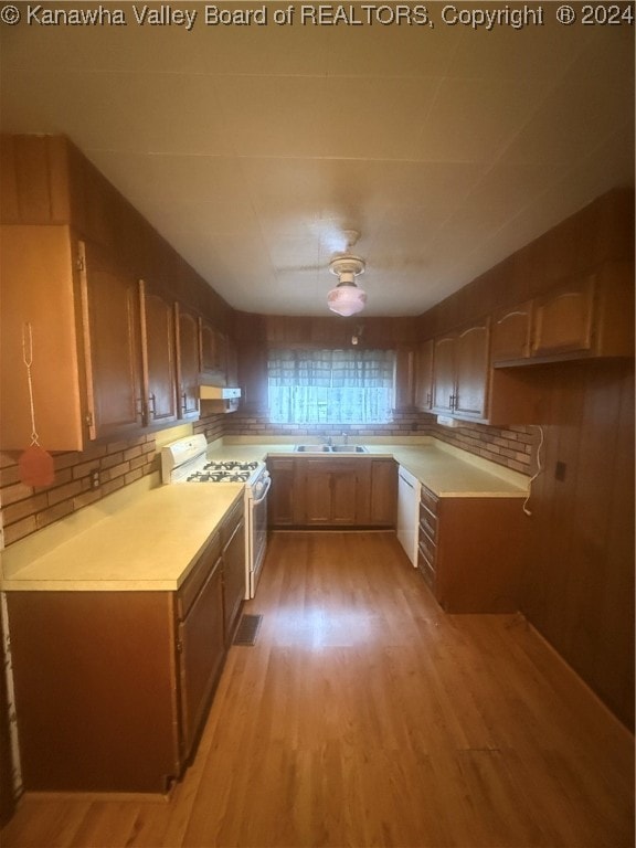 kitchen featuring light hardwood / wood-style floors, white appliances, sink, and extractor fan