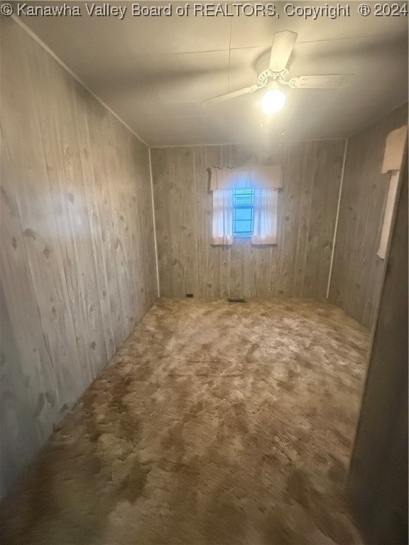 basement featuring carpet flooring and ceiling fan