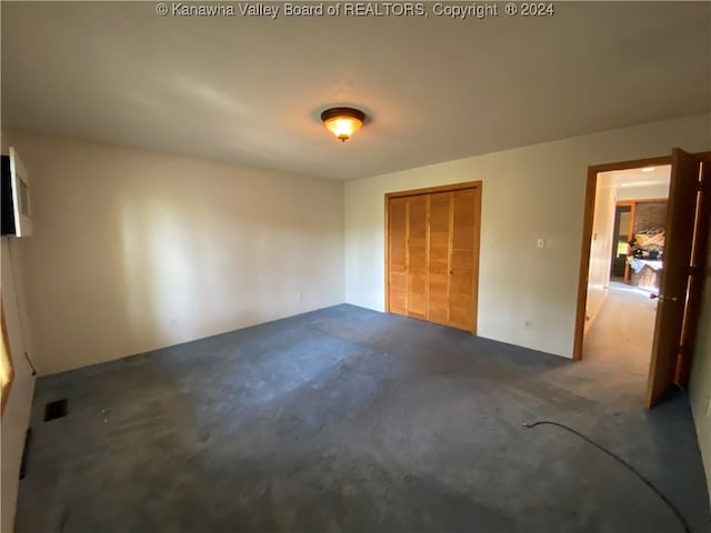 unfurnished bedroom with carpet floors and a closet